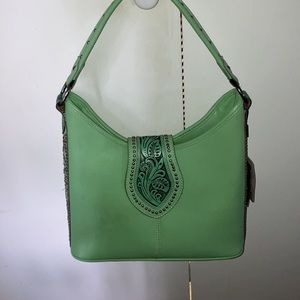 Green Montana west shoulder purse never been used. Still has tags on it. Great